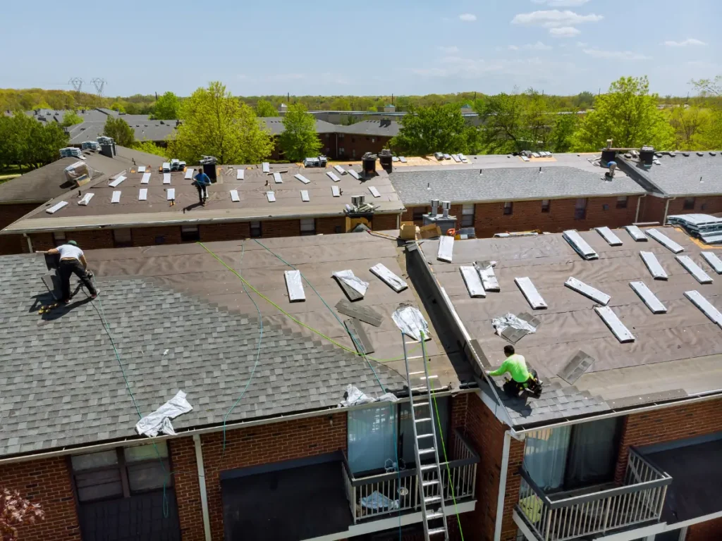 a group of people installing a commercial roof system