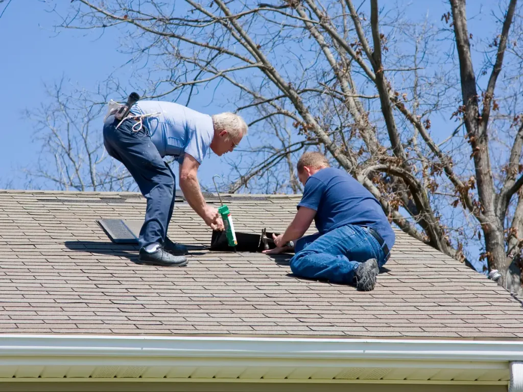 commercial roofing contractor employees working on a roof