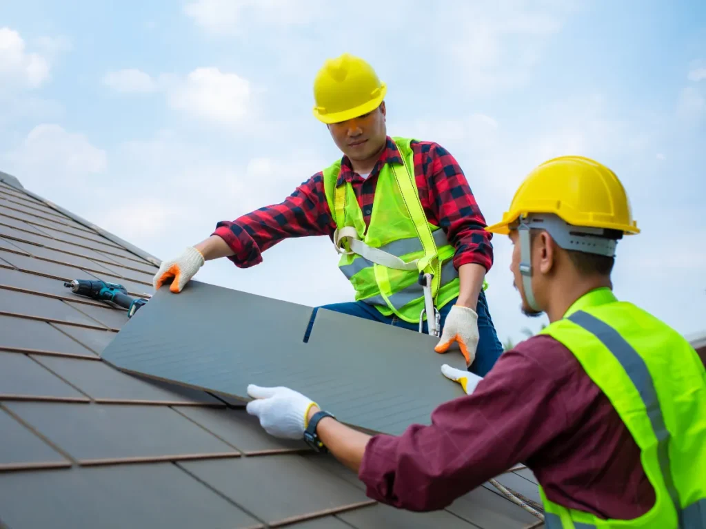 a group roofing contractors wearing safety vests and helmets