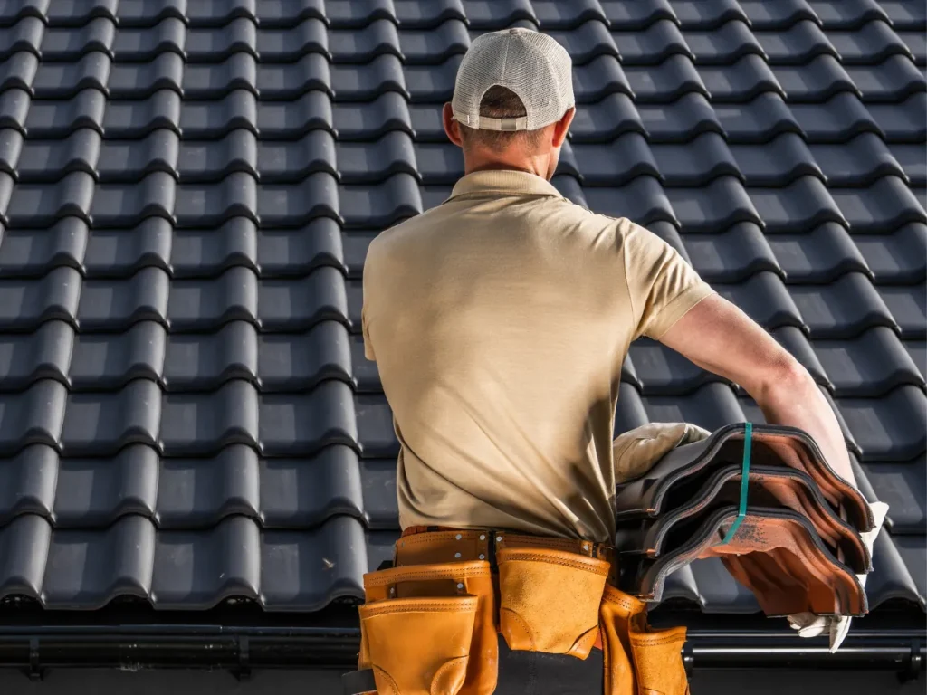 a man standing on a roof works for a professional roofing company