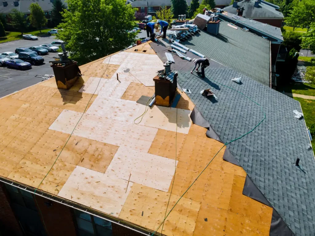 a roof with a few workers on it working for a local roofing company