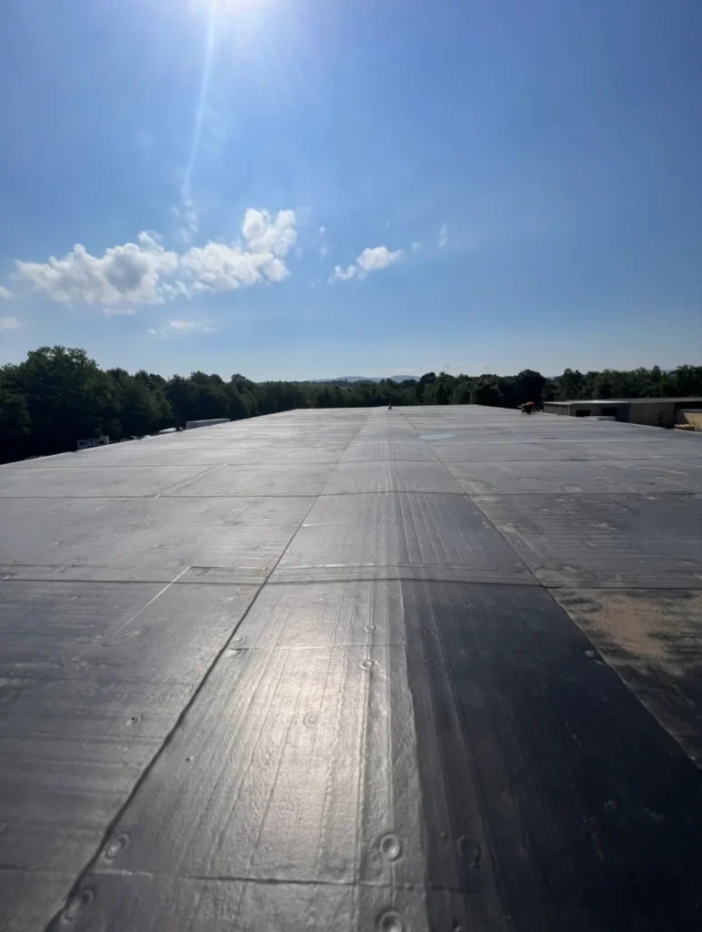 A clean black commercial flat roof membrane fully sealed and prepared for winter weather conditions in Northeastern Pennsylvania (NEPA).